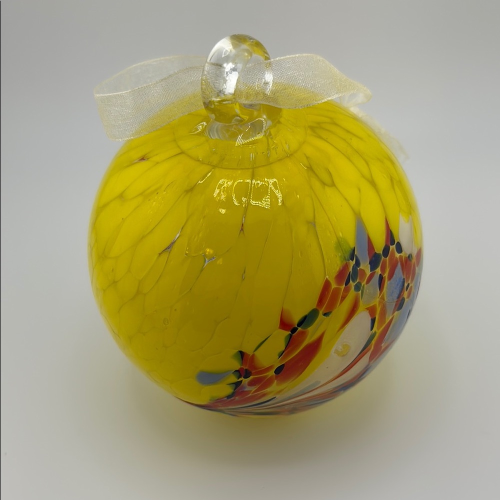 Hand Blown Yellow Glass Ornament with Ribbon.  Approximately 4” wide.